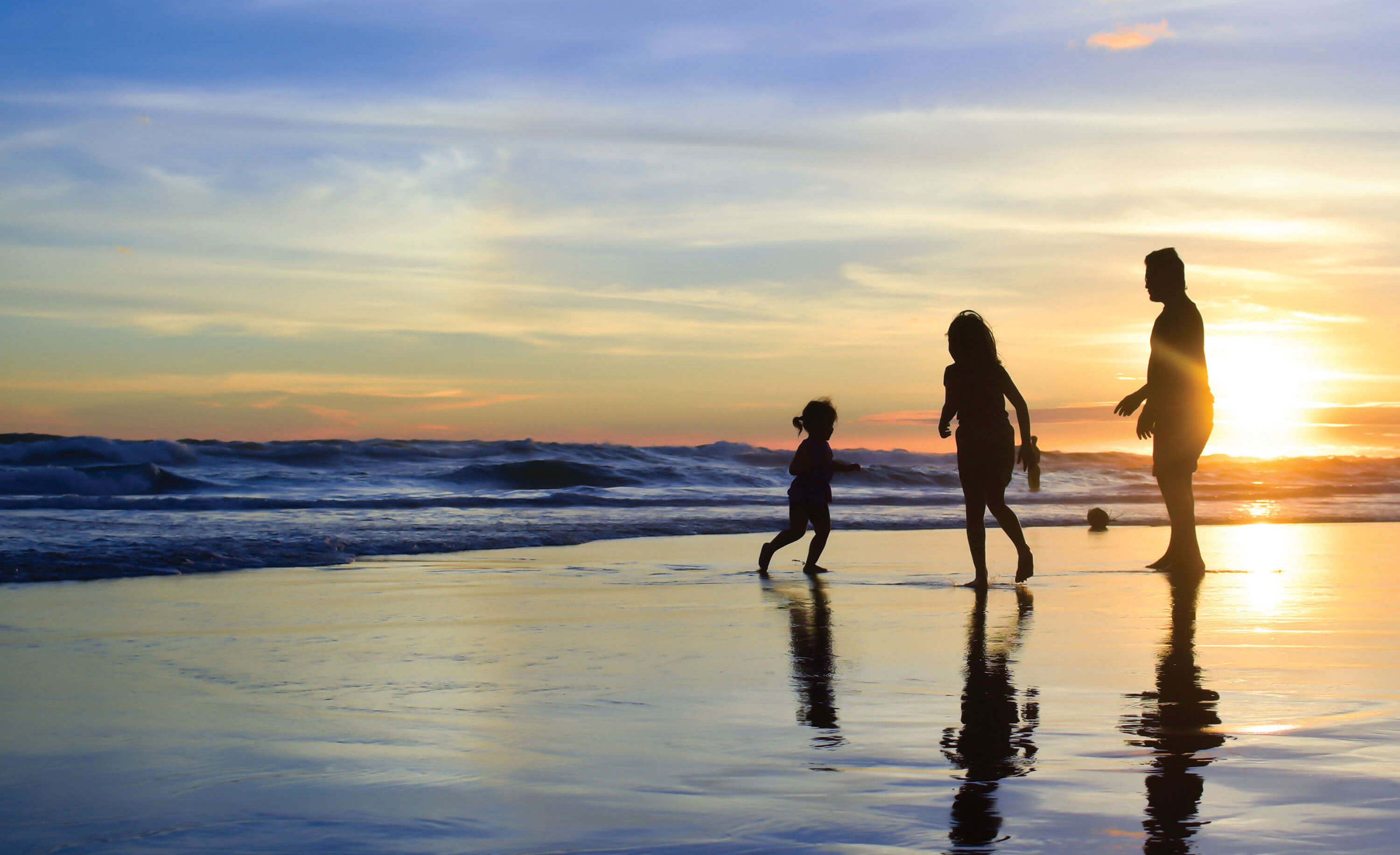 A family enjoys playing by the water